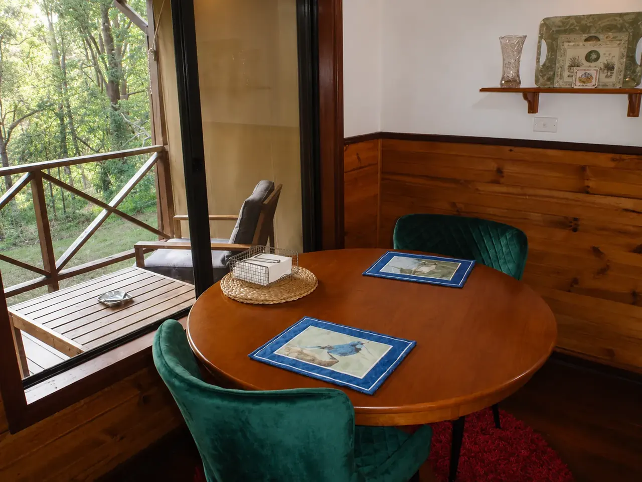 The dining nook beside the window, looking out to the verandah and bush