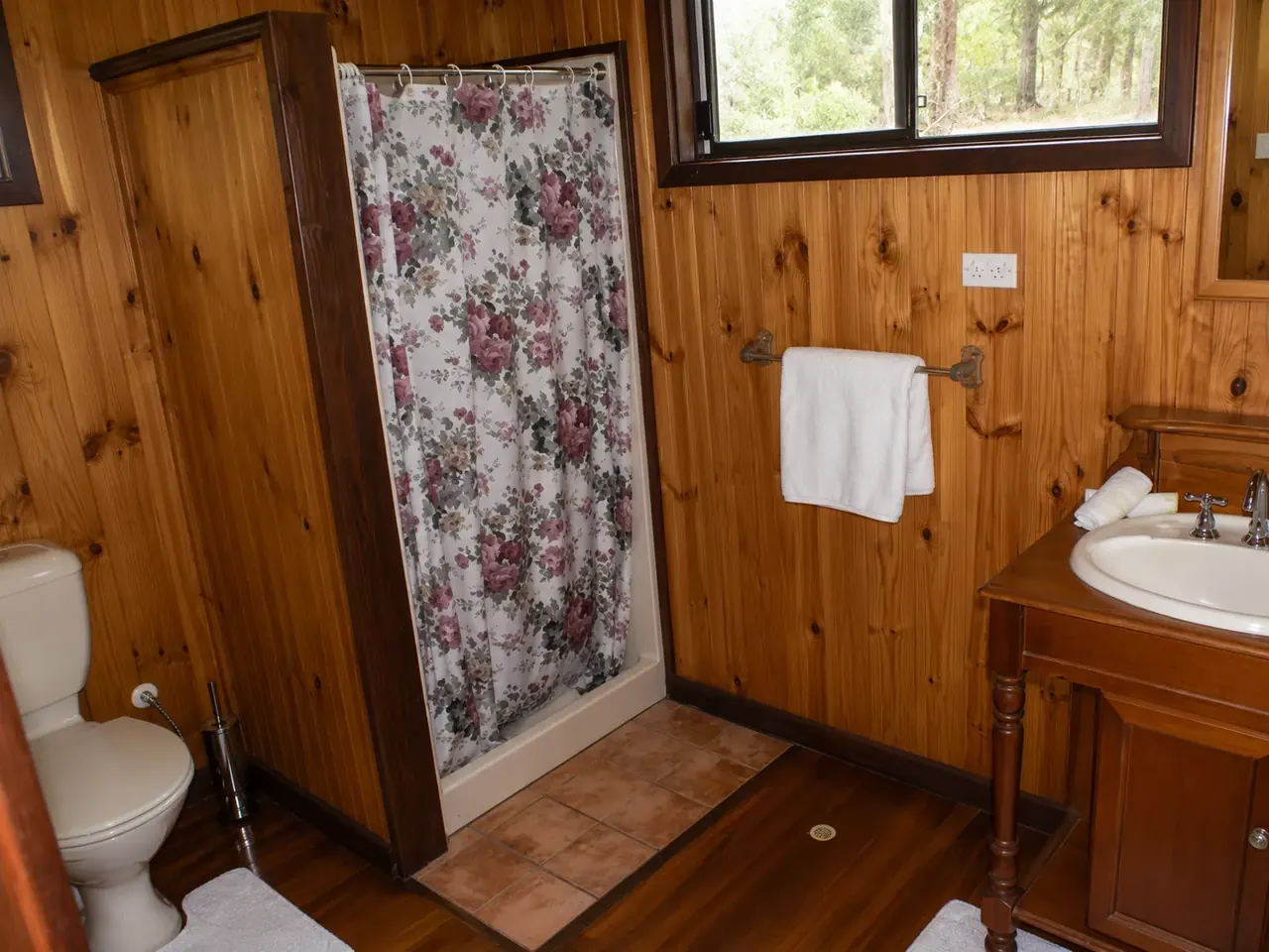 The timber bathroom, with a separate shower and vanity