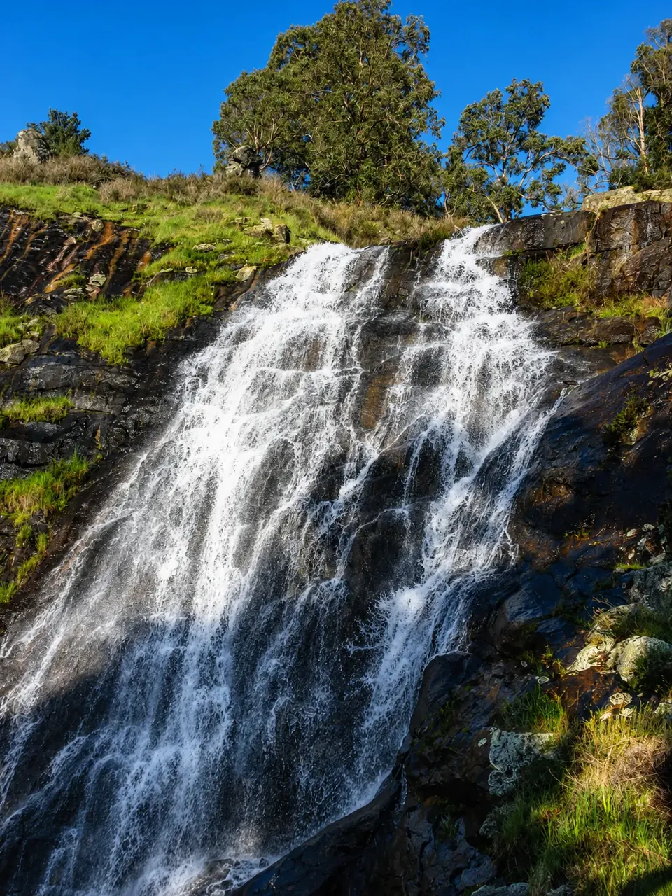 Beyonderup Falls sheeting down the granite face on a bright winter day