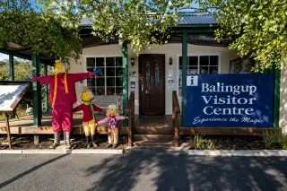 The Balingup visitor-centre cottage, its scarecrow figures out front